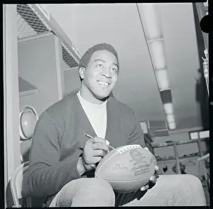 Leroy Kelly Autographing a Football