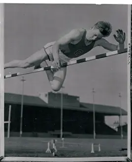 Prints of (Original Caption). Eugene, Oregon: Les steers shown clearing the bar at 7 feet, 1/2 inch during exhibition before 6, 000 persons who gathered to watch Oregon State College basketball game Hoops Through Time: A Visual Journey of Basketball History: Les Steers in Pole Vaulting Action