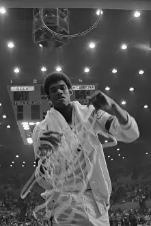 Kareem Abdul-Jabbar Prints: Lew Alcindor Holding Basketball Net