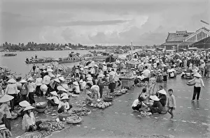 Prints of Vietnamese women, wearing traditional non la hats, selling fresh produce on an embankment of the Saigon River as it flows through Saigon, Vietnam, 30th August 1965 Vietnam Prints: Life Along The Saigon River