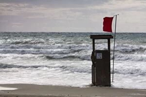 Windy Gallery: Lifeguard watch tower on the beach of Playa TorA┬âA┬í with a red Flag and waves, Peguera, Majorca