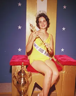 Linda Bement Posing with Miss Universe Trophy