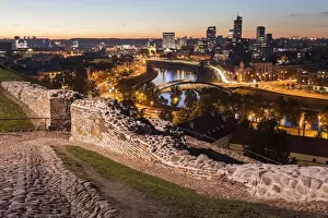Cobblestone Prints: Lithuania, Vilnius, Illuminated riverfront cityscape seen from elevation on opposite bank