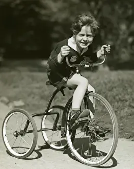 Little boy riding his tricycle
