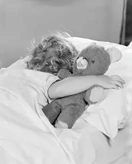 Only Girls Prints: Little girl asleep in bed, with arm around teddy bear