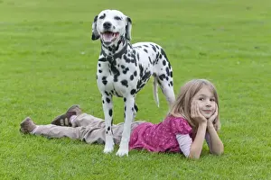 Resting Prints: Little girl lying under a Dalmatian