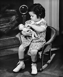Little girl playing with doll