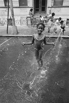 Little Girl Skips in Spray of Hydrant