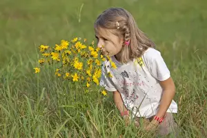 Flowering Prints: Little girl smelling flowers