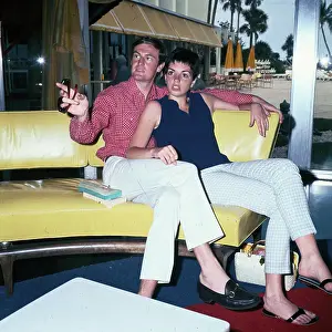 Liza Minelli and Peter Allen Sitting on Yellow Leather Sofa