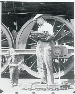 Locomotive Engineer Holding Model Train