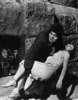 Lon Chaney as Quasimodo in Hunchback of Notre Dame carrying Esmeralda