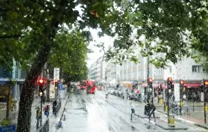Incidental People Collection: London street scene through rain-soaked bus windows, London, England, United Kingdom