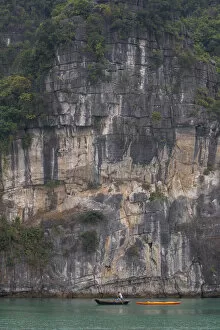 Rock Face Gallery: A lone oarsman dwarfed by nature