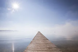Mist Collection: Very long jetty on Chiemsee Lake with high fog and sun near Seebruck, Bavaria, Germany, Europe