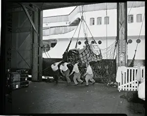Unloading Prints: Long Shoremen Pulling Net; Working