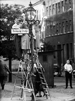 Prints of West Berliners stand on a pair of ladders as they wave across the Berlin Wall at Bernauer Strasse, West Berlin, Germany, 1961. (Photo by PhotoQuest/Getty Images) Berlin Wall (Antifascistischer Schutzwall) Prints: Looking Over Berlin Wall