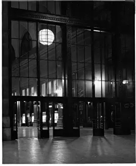 Penn Station: Echoes of Transit: Looking Through Entrance Of Penn Station At Night In New York City