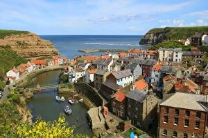 Village Gallery: Looking seawards over cottage rooftops of the fishing village of Staithes, North Yorkshire, England