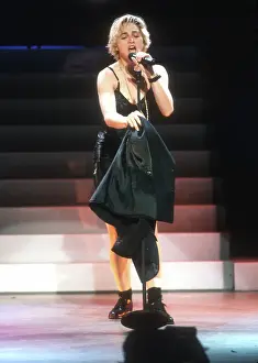 Prints of LOS ANGELES - SEPTEMBER 1989: Pop singer Madonna performs onstage in spandex and a bustier with back up dancers in September 1989 in Los Angeles, California Experience the Evolution of the Queen of Pop: Los Angeles Concert