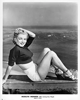 Prints of CIRCA 1953: Actress Marilyn Monroe poses for a portrait sitting on a bench in front of a view of the ocean in circa 1953. (Photo by Michael Ochs Archives/Getty Images) Marilyn Monroe: The Eternal Star Prints: Lovely View