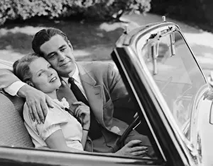 Loving couple in sports convertible