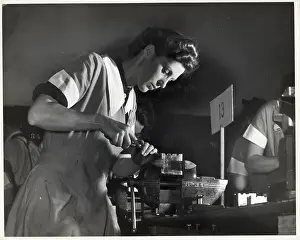 Laborer Prints: Low Angle Woman Scrapes Bearing In Class