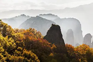 Thessaly Prints: Low cloud around the rugged cliffs with foliage in autumn colours