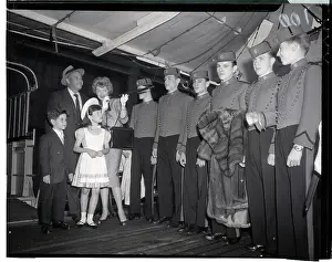 Comedienne Prints: Lucille Ball and Family with Row of Bellhops