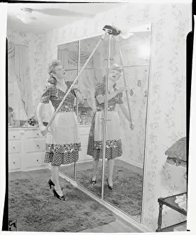 Prints of (Original Caption). Lucille Ball is shown at her home Behind the Laughter: Lucille Ball's Unseen Moments: Lucille Ball Washing Mirror