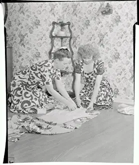 Prints of (Original Caption). Lucille Ball is shown at her home Behind the Laughter: Lucille Ball's Unseen Moments: Lucille Ball Working at Table with Kerosene Lamps