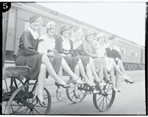 Prints of (Original Caption). Seven beautiful girls, models for famous posters and magazine advertisements, are shown as they arrived in Los Angeles, July 19th Behind the Laughter: Lucille Ball's Unseen Moments: Lucille Ball and Young Accomplices Sitting With Legs Crossed