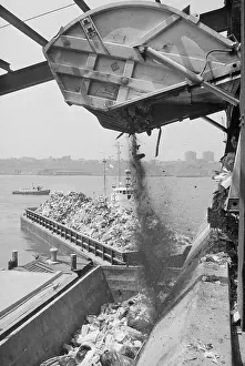 Waste Prints: Machine Loading Garbage onto Barge