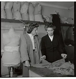 Mad Carpentier and Assistant Discussing Fabric