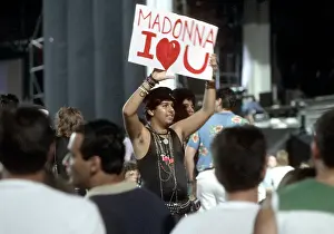 Prints of LOS ANGELES - AUGUST 6: Fans look on as pop singer Madonna performs onstage on August 6, 1987 in Los Angeles, California. (Photo by Michael Ochs Archives/Getty Images) Experience the Evolution of the Queen of Pop: Madonna Fans