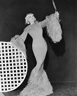Mae West Posing in Feathered Gown