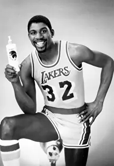 Prints of A half length portrait of basketball player Magic Johnson, wearing his Los Angeles Lakers no 32 shirt, advertising a hair product, 1980. (Photo by Afro American Newspapers/Gado/Getty Images) Courtside Vibes: Stunning Basketball Prints: Magic Johnson Ad