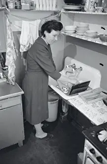 Clean Prints: Maid Cleaning Dishes in Apartment
