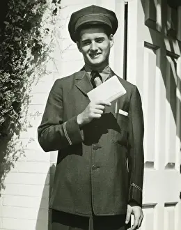 Delivery Prints: Mailman holding blank form outdoors, (B&W), portrait