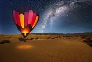 Images Dated 8th August 2015: A majestic hot air balloon soars under the stars of the Milky Way