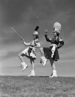 Uniform Gallery: Two majorettes in uniform doing routine with batons