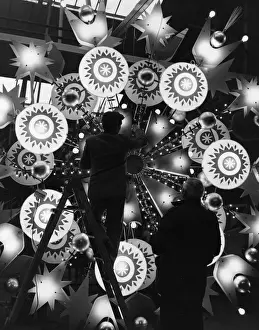 Prints of Two assistants at Chrysaline Limited at Chesham working on one of the huge illuminated Christmas decorations for Oxford Street, London. (Photo by Fox Photos/Getty Images) Timeless Treasures: Iconic Black and White Prints from the Fox Photo Library: Making Illuminations