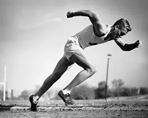 Male runner jumping from starting blocks at beginning of race