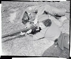 Male Soldier Teaching Weapon Techniques to Female Officer