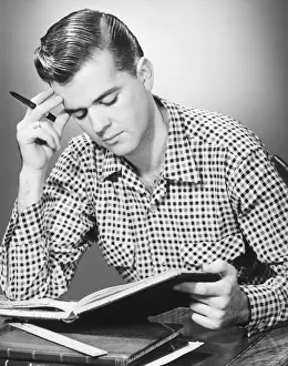 Male student reading, (B&W)