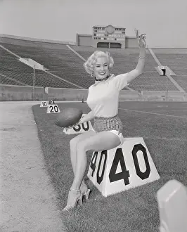 Mamie Van Doren Posing on Football Marker on The Field