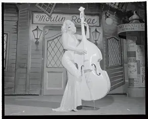 Mamie Van Doren Posing by Large Fiddle