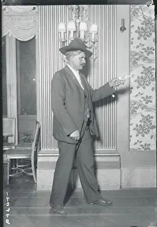 Caution Prints: Man Aiming Gun in Parlor