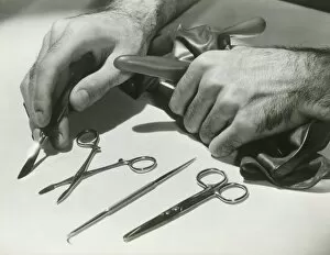Man arranging surgical tools, close up of hands