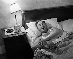 Man Asleep in His Bed